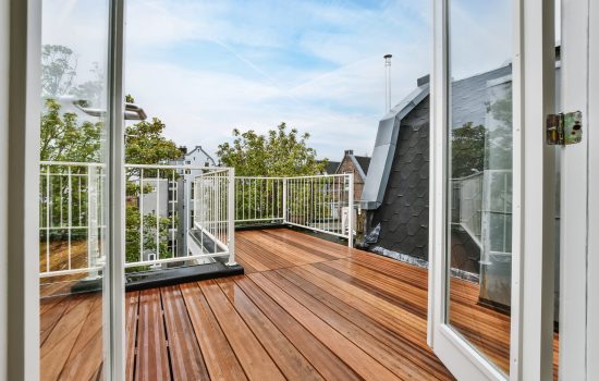 Rooftop exterior with delightful wood flooring and white railings